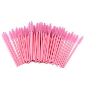 A pile of pink mascara wands against a white background.