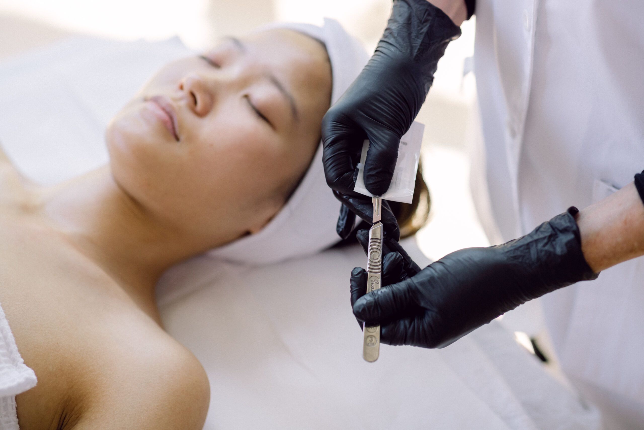 person showing dermaplaning blade