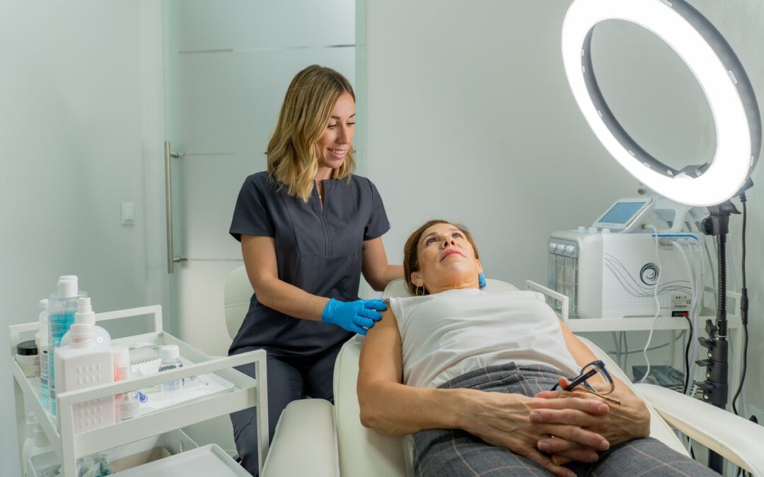 alumni performing a facial on a client after the the Skin Esthetician Course in Winnipeg