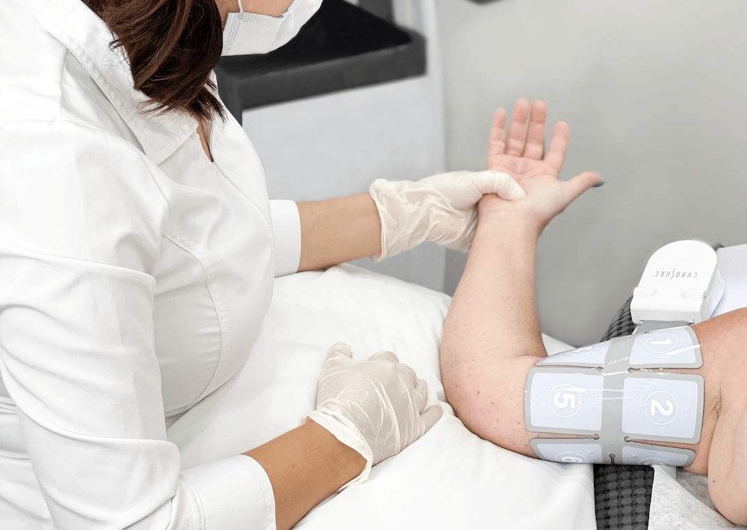 Esthetician performing an rf body contouring service on a client