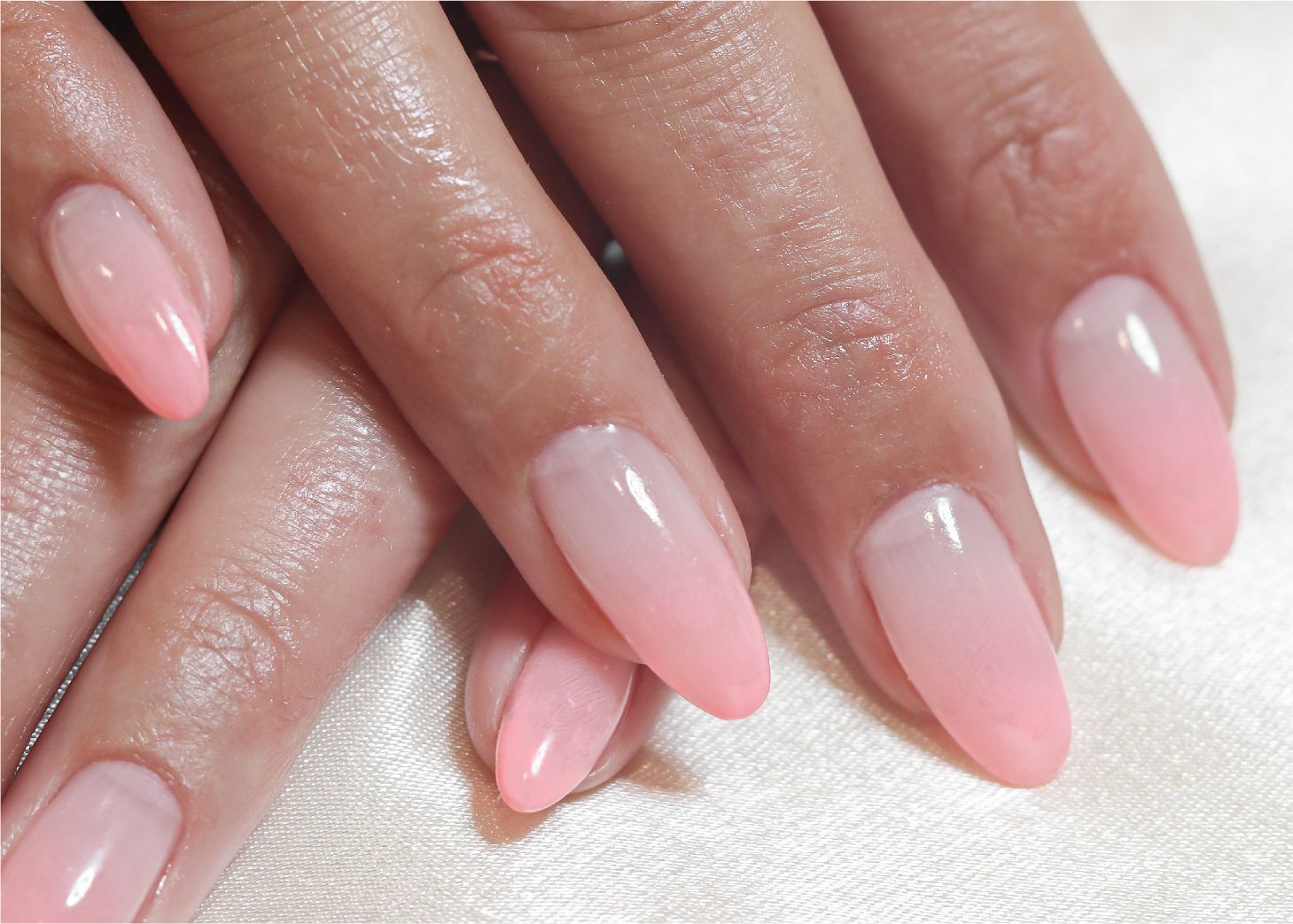 Manicured hands with gradient pink polish