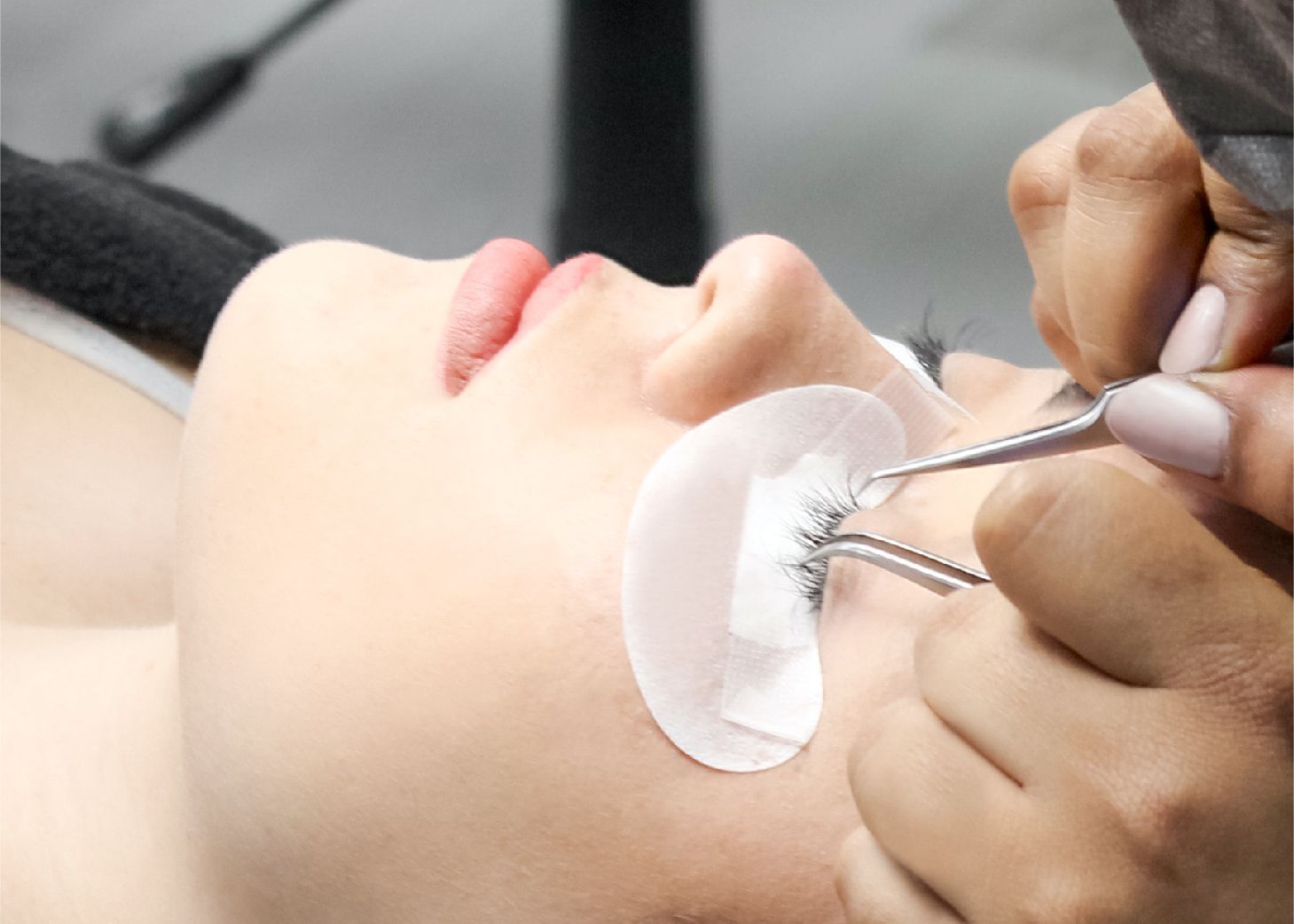 Model receiving lash extensions at Wrapture Beauty Academy