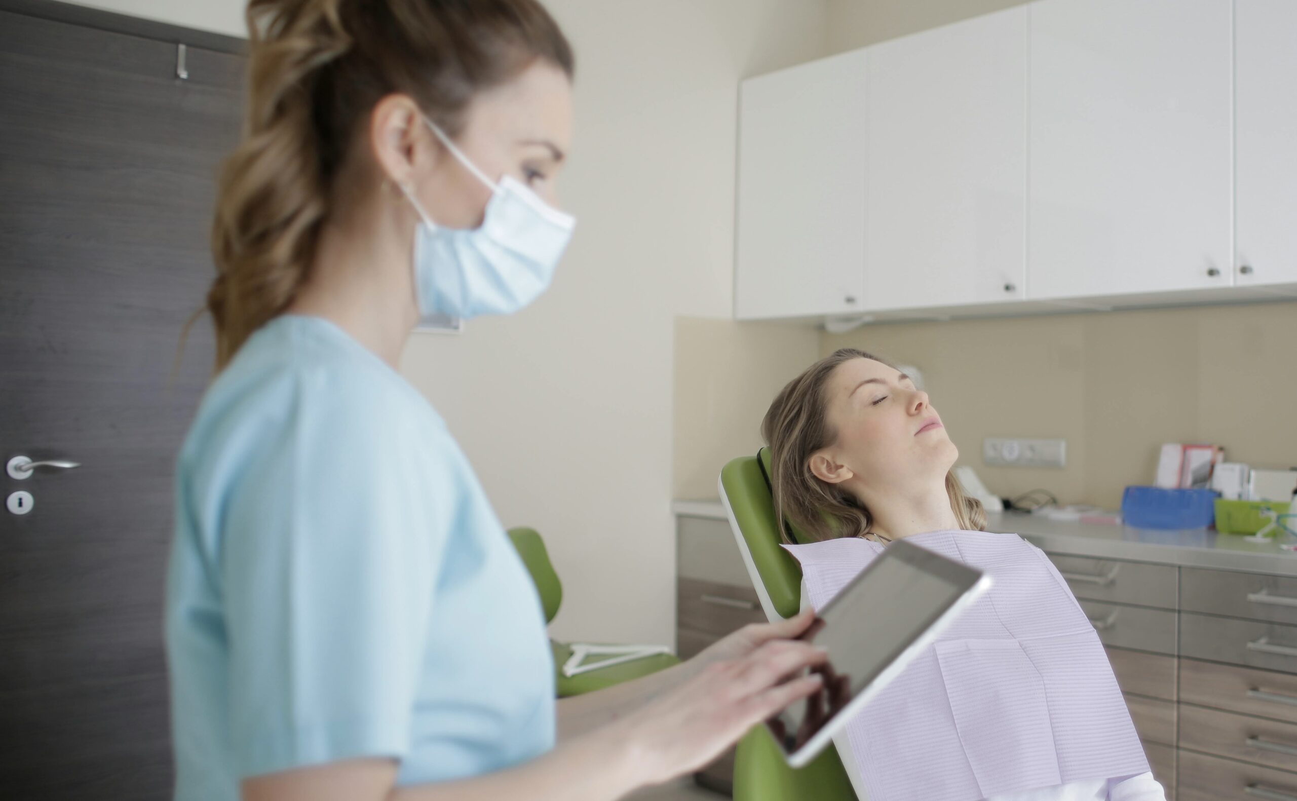 beauty professional learning a new skin care service online while a model waits to be practiced on