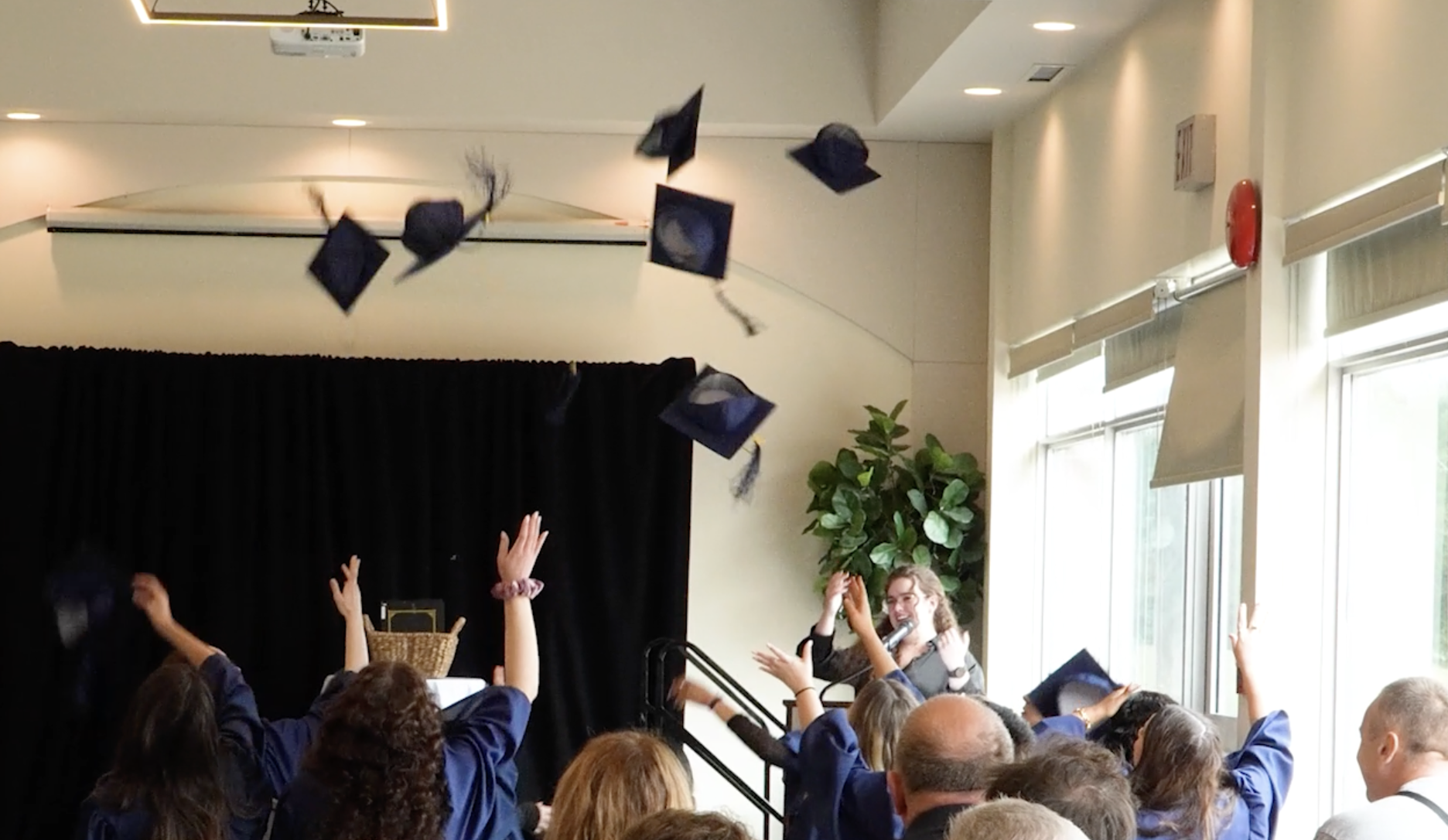 Graduates throwing their caps in the air in celebration