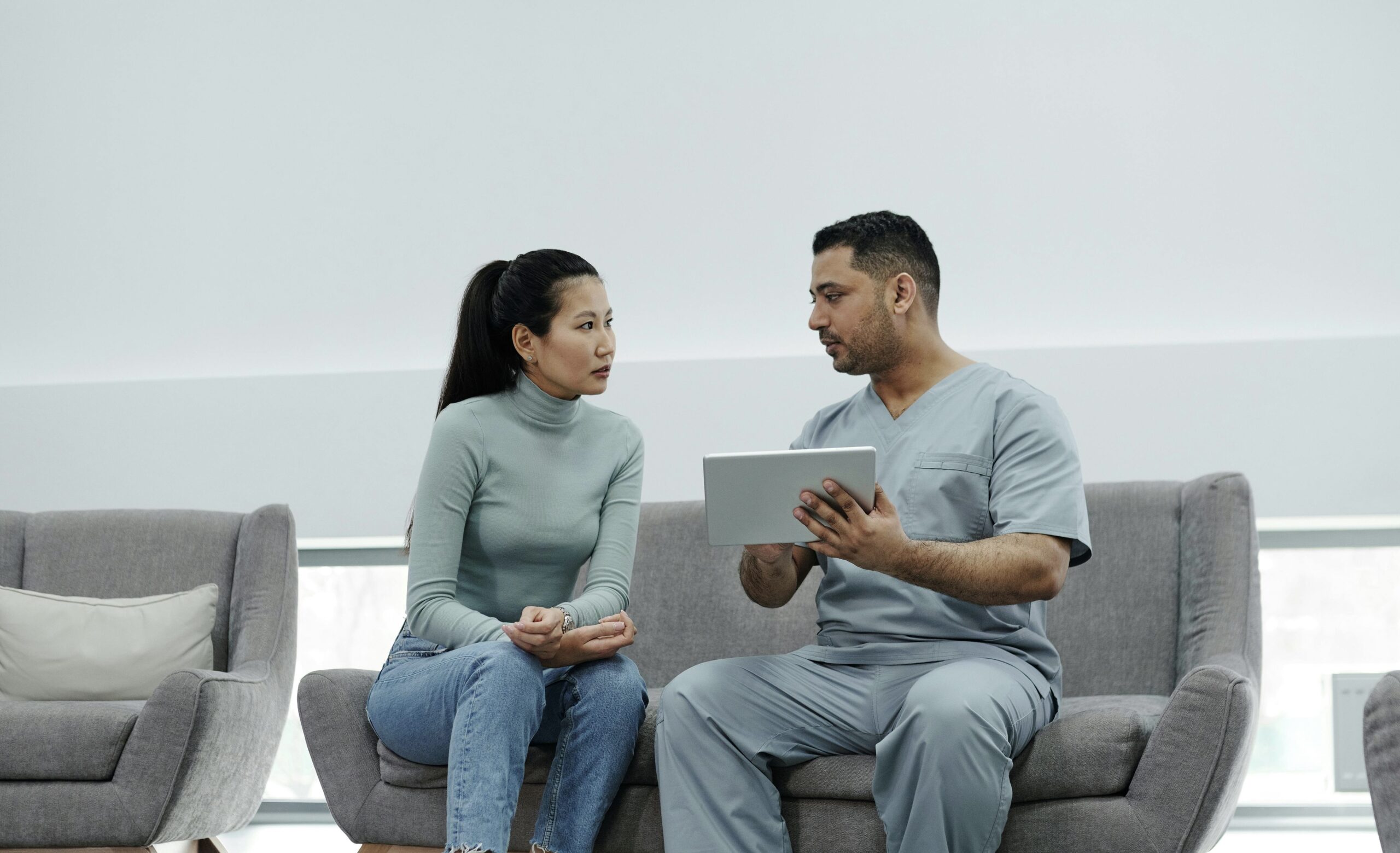 Esthetician connecting with a client to explain daily skincare ingredient recommendations 