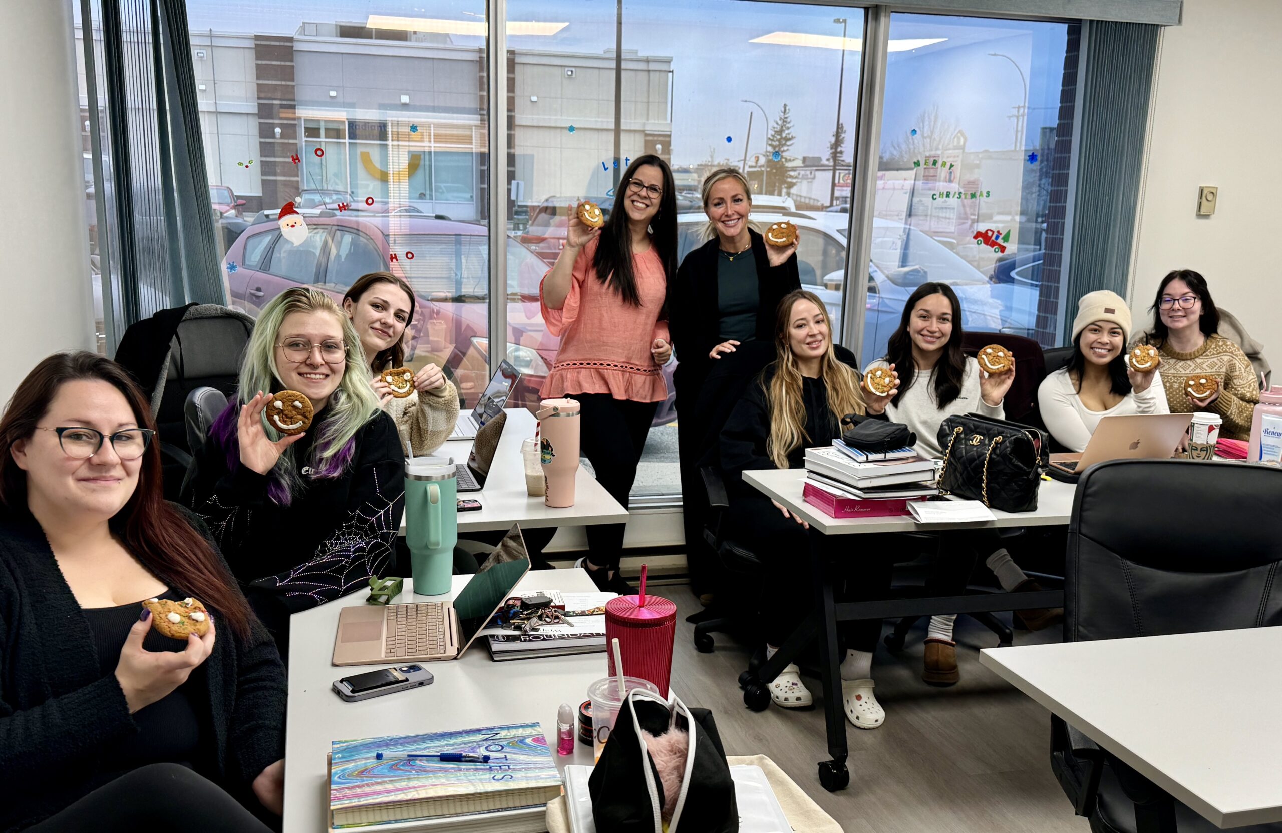 Kelsey's classroom with students holding up smile cookies for the cheer board fundraiser. A great community moment