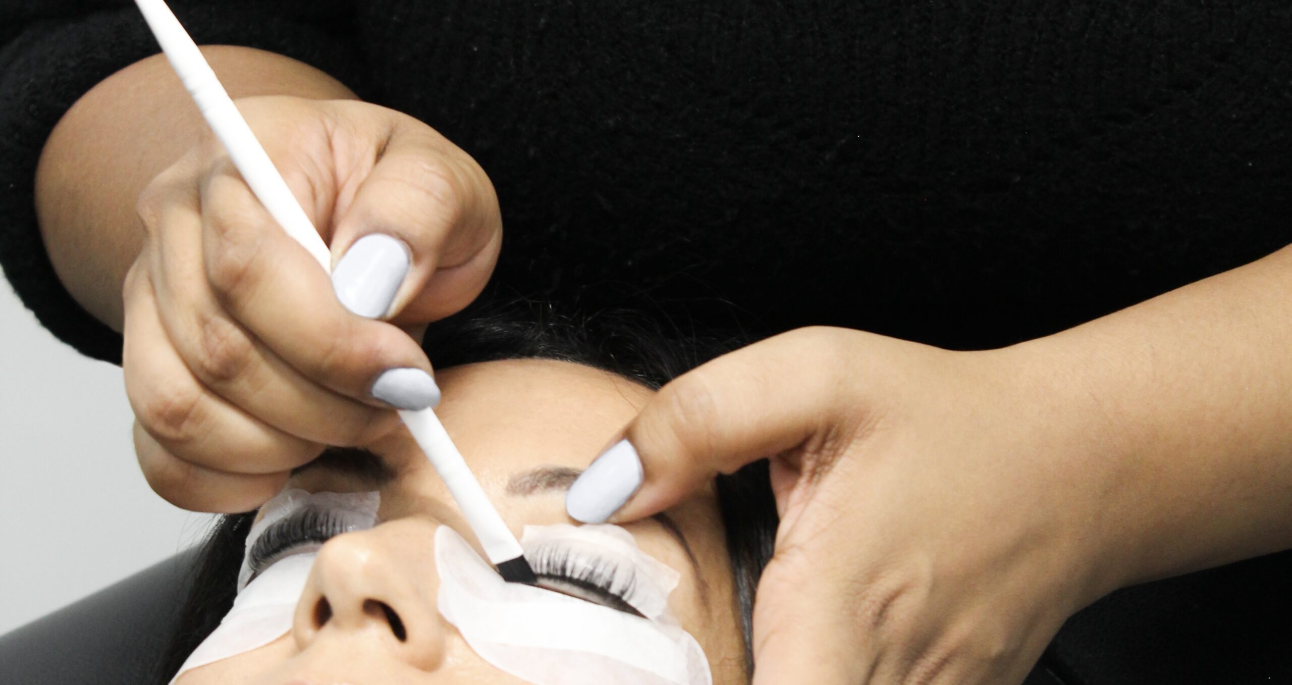 a student practicing a lash lift