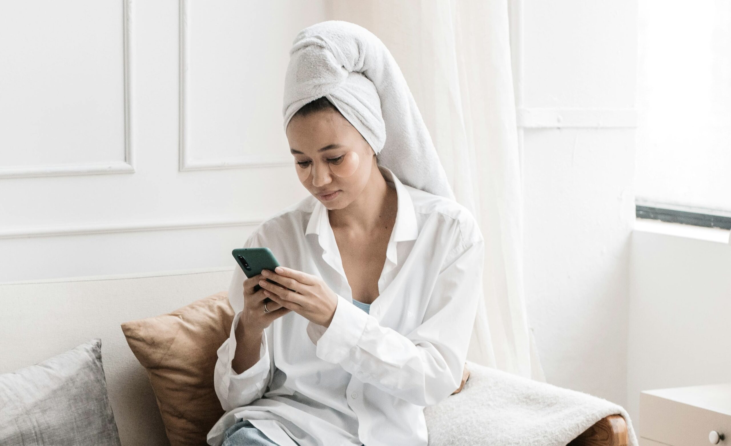 Model on her phone following a winnipeg beauty school student so she can continue being her client