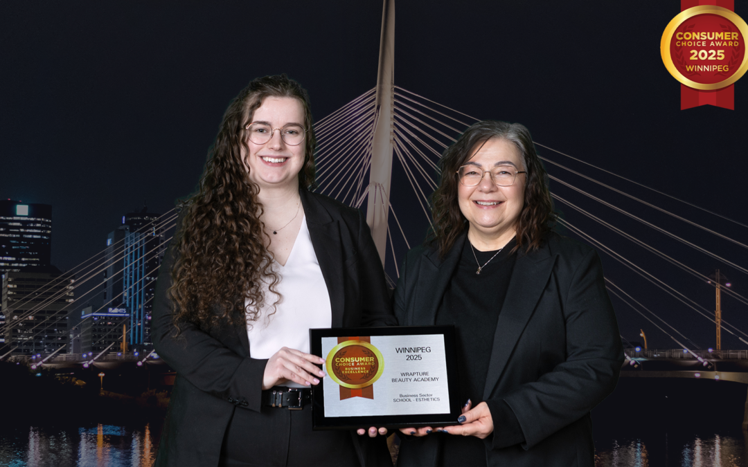 Two women dressed in black holding up an award against a backdrop of a Winnipeg landmark. Mel and Jenna at the CCA Consumer Choice Awards 2025 for Best Esthetics School in Winnipeg.