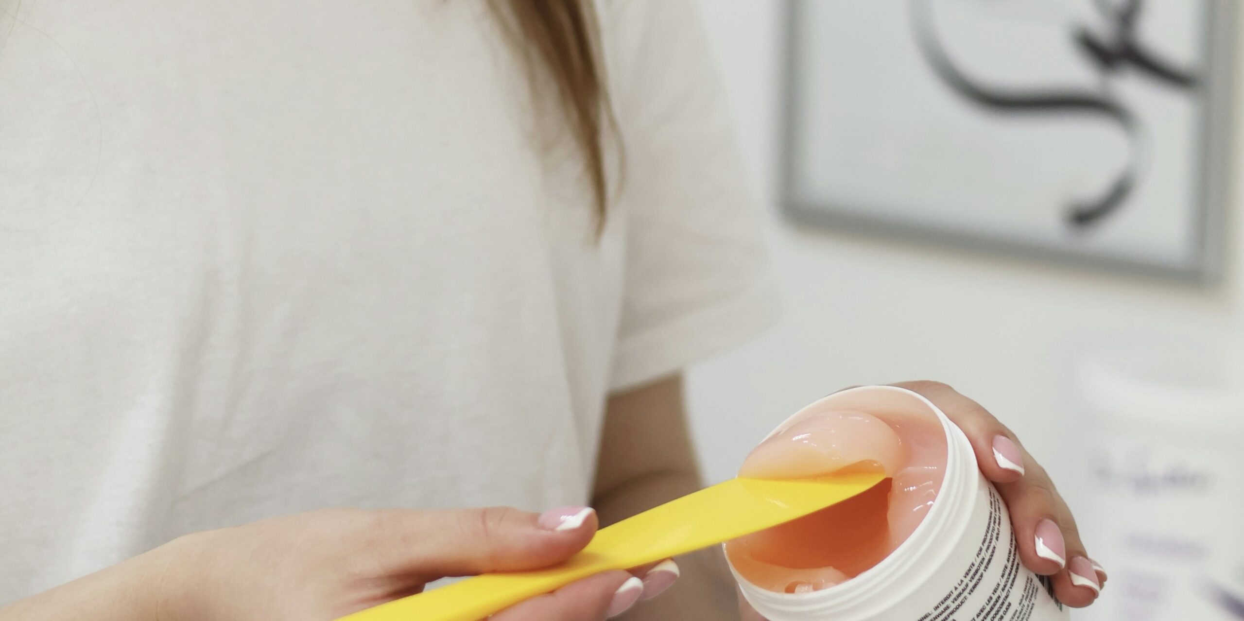 A person scooping up gel