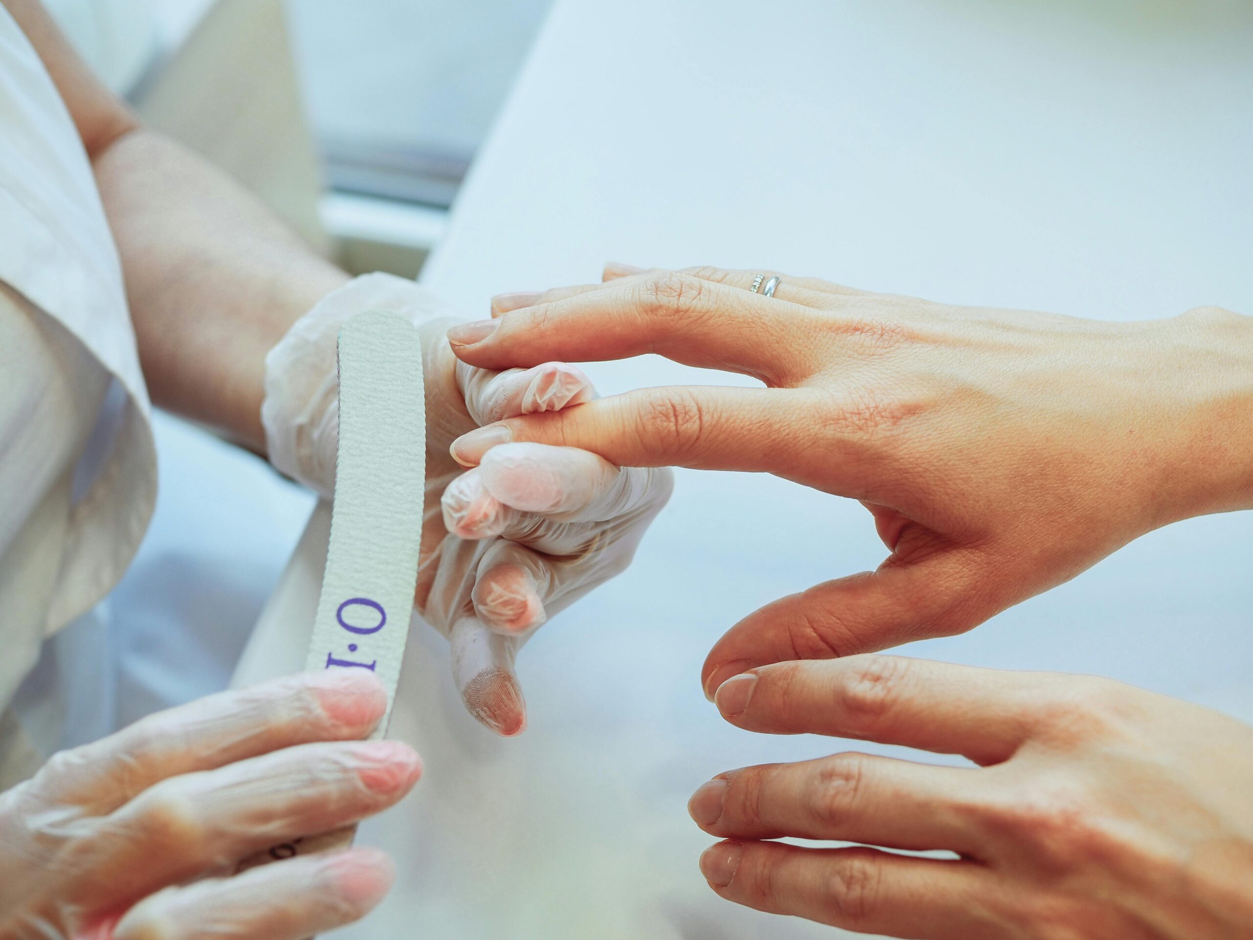 student filing nails during a manicure