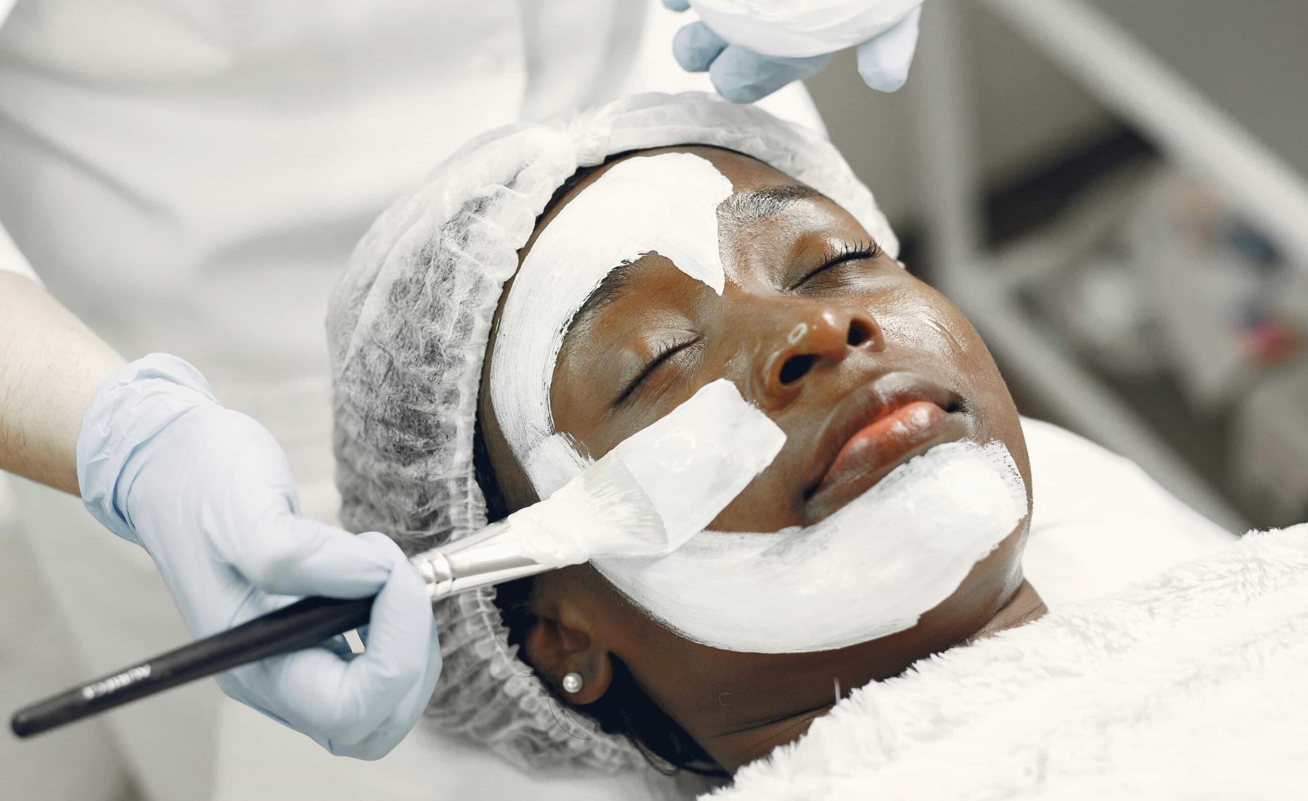 Hands-on training with a model receiving a facial during a skin esthetician course Winnipeg, showing practical technique.