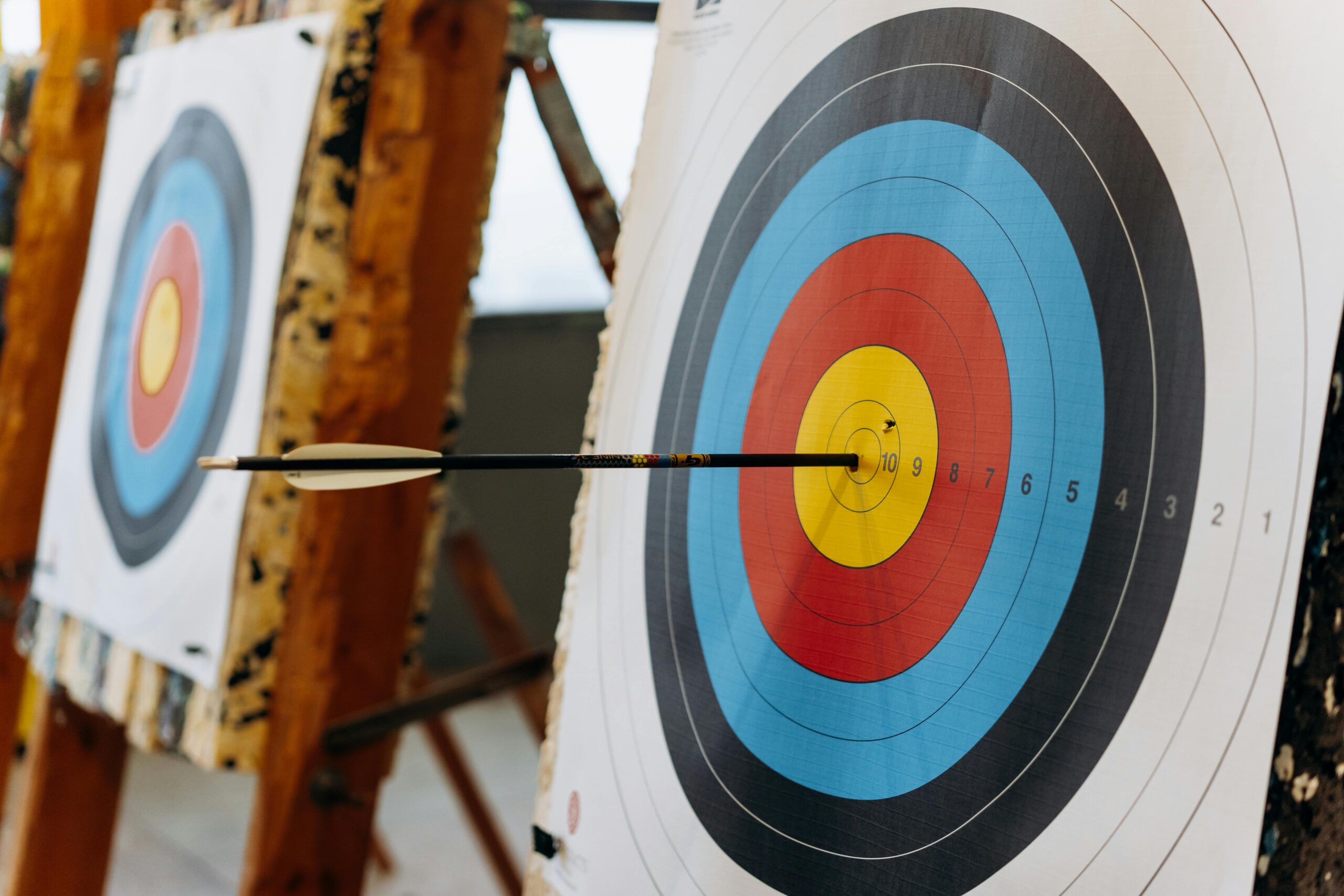 Arrow hitting the bullseye of a target, symbolizing the power of intentional marketing with clear focus on one service. (dermaplaning spotlight article)