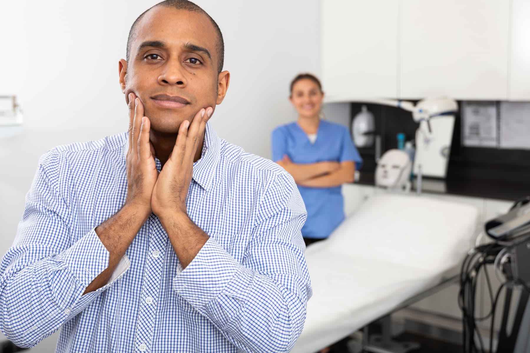 Man assessing his skin after a professional treatment, showing the importance of targeted skincare ingredients for visible results.