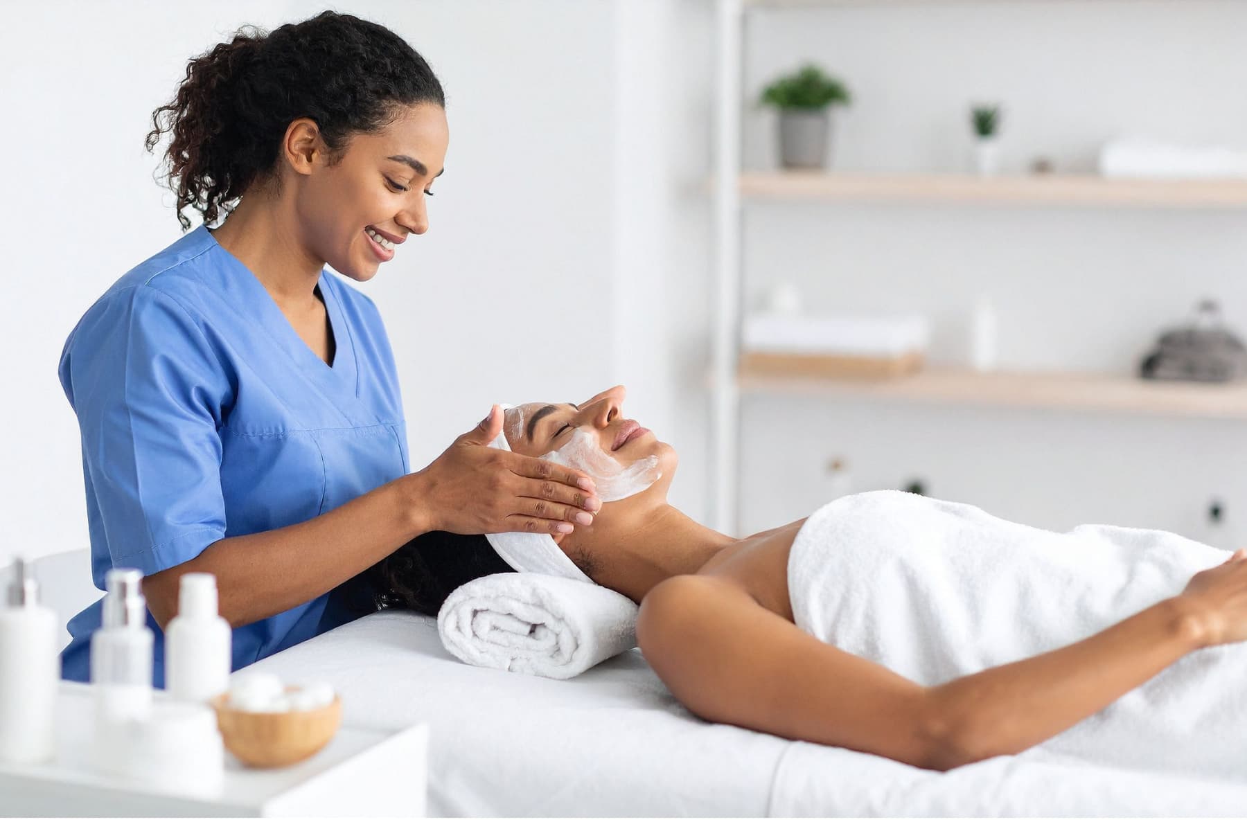 Esthetician performing a facial treatment while applying a gentle cleanser, illustrating hands-on techniques used before choosing the right skincare ingredients for clients. facial
